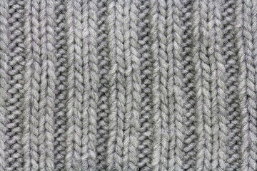 Knitted gray fabric from natural wool texture, background elastic