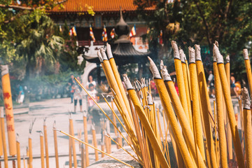 Closeup view of burning incense sticks during prayer at the Buddhist temple, Po Lin Monastery in...