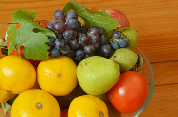 fruit in a glass bowl on a wooden table