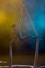 Graceful gymnast performing aerial exercise