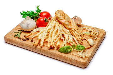 Smoked braided cheese and vegetables on white background