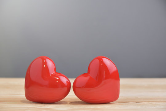 Two Red hearts on Blue and wooden background.