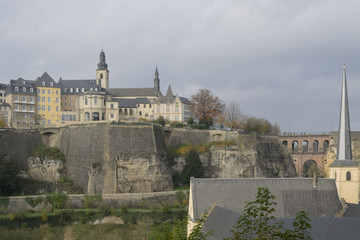 Detail of famous Luxembourg city line in November with Saint Michael Cathedral and yellow and brown autumn trees, Luxembourg.