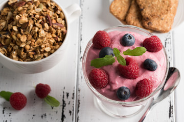 Healthy breakfast: Curd soufflé with fresh blueberry, raspberries, granola and tea
