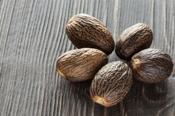 Nutmeg, on a wooden background, close-up