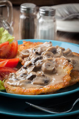 Crispy fried homemade potato pancakes with mushroom sauce.