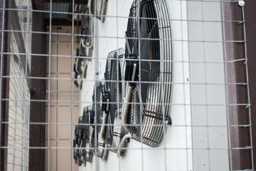 outdoor air conditioning units behind bars