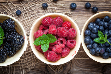 Blackberries, raspberries and blueberries in a waffle bowls.