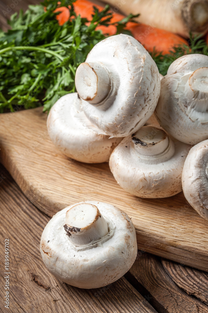 Wall mural Fresh mushrooms on cutting board.