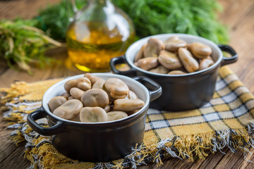 Broad beans served in black bowls.