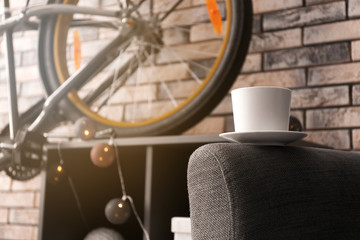 Ceramic cup on armchair indoors