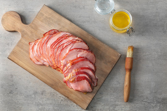 Delicious sliced honey baked ham on wooden board