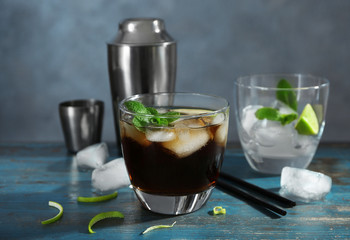 Composition with Cuba Libre cocktail on table
