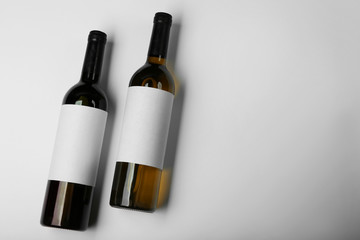 Wine bottles with blank labels on light background. Mock up for design
