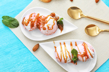 Tasty berry ice-cream with caramel topping on plates, top view