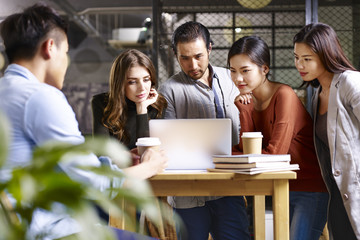 Group of young business people meeting in office