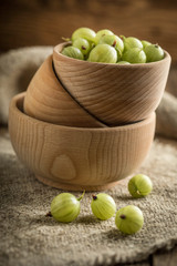 Fresh gooseberry in a wooden bowl.