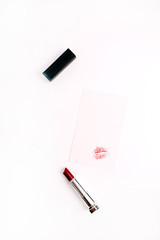 Female kiss shape on paper with red lipstick. Lifestyle flat lay, top view fashion concept.