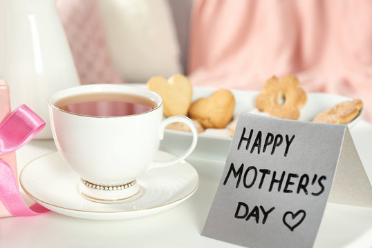 Cup of tea and card on table. Mother's day breakfast