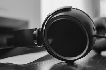 Black pair of headphones close-up, black and white images
