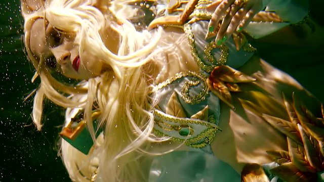 Portrait of a girl elf under water in the dark. dressed in the armor of a warrior and dress.
