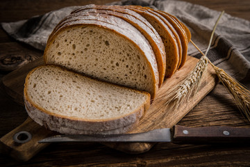 Sliced loaf of bread on a chopping board.