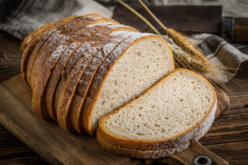 Sliced loaf of bread on a chopping board. © Arkadiusz Fajer