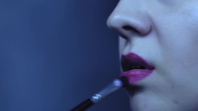 using makeup for lips on a beautiful woman