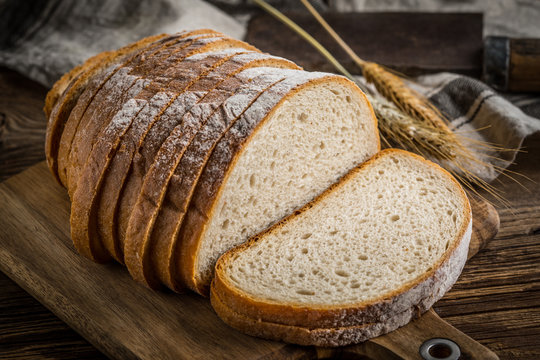 Sliced loaf of bread on a chopping board.