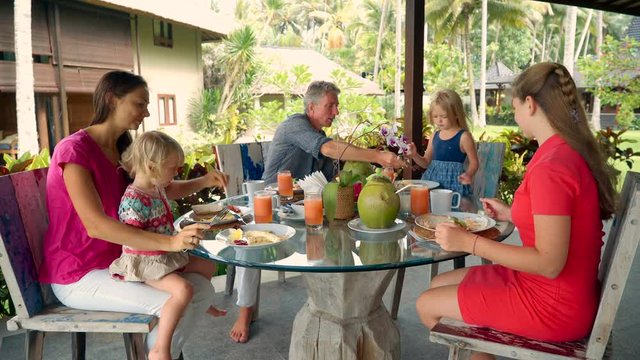 Caucasian family having breakfast on outdoor terrace
