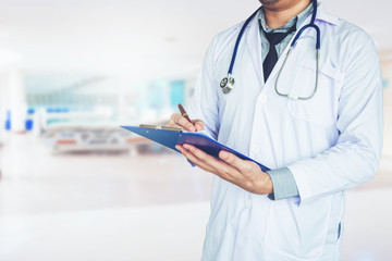 Doctor holding clipboard and stethoscope on background of Hospital ward