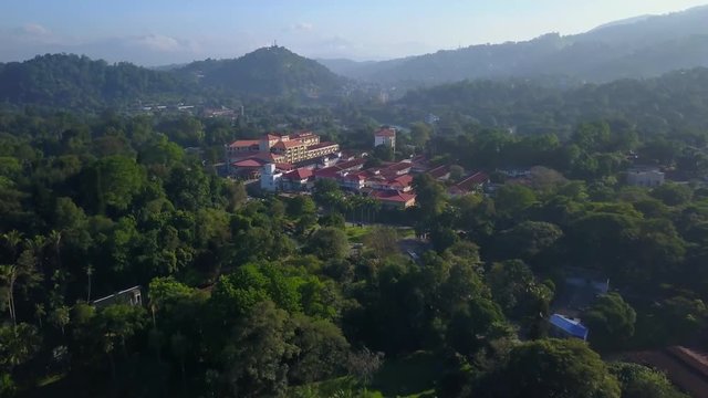 Aerial view of beautiful building at lush forest in mountains drone footage