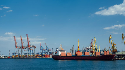 Fototapeta premium cargo ship stands in an industrial port on a sunny day
