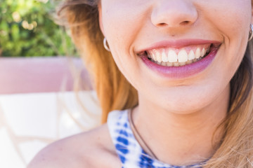 close up of a young woman smiling with perfect teeth