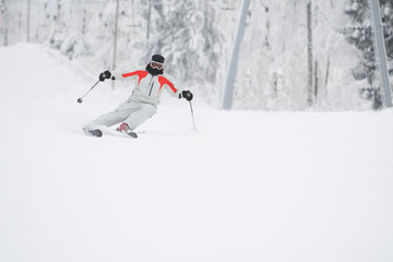 Fototapeta na wymiar Alpine skier skiing downhill