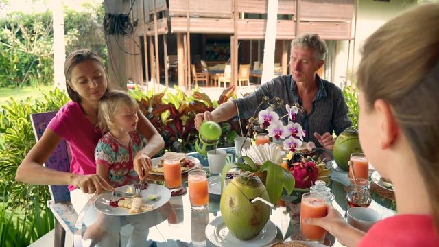 Caucasian family having breakfast on outdoor terrace