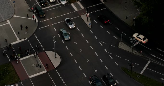view of people and traffic crossing busy intersection at the evening