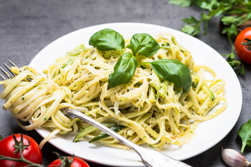 Pasta spaghetti with zucchini basil and cheese.