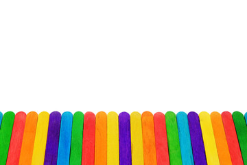 Colorful wooden ice-cream stick line up in horizontal on white background.