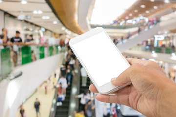 smartphone with abstract blur in shopping mall background.