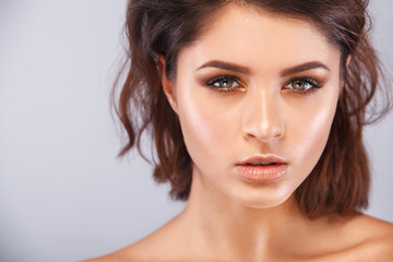 Closeup portrait of beautiful young woman with clean and fresh skin. Nude makeup. Facial treatment . Concept for cosmetology, beauty and spa .