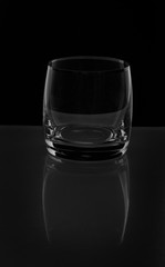 One empty glass on black