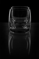 Two empty glass on black