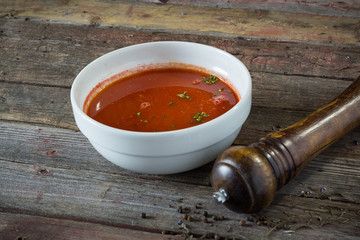 Tomato soup. On a wooden background. rustic food