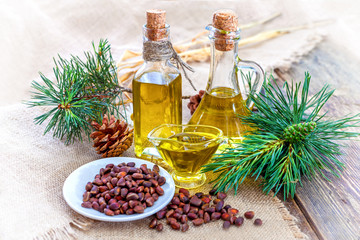 Cedar oil in glass jars on a wooden table