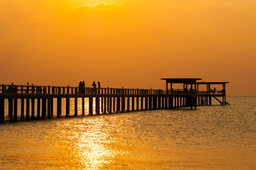 Fototapeta na wymiar Silhouette of wooden bridge at sunset.