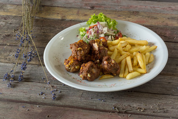 Vegetarian food - zucchini fritters on wooden background.