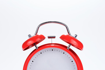 Close up of an old retro red alarm clock without numbers