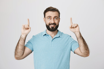 Picture of handsome middle aged man smiling and pointing his fingers up in a happy pose. So here is how victory feels like. Guy visited gym for 2 weeks and finally lost weight.