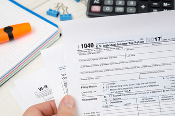 Man holding US tax form 1040